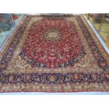 A hand knotted woollen Kashan rug, 3.95m x 2.95m, in good condition