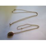 A 9ct gold locket on a 9ct chain and a 9ct pearl pendant on a 9ct chain, total weight approx 8.9