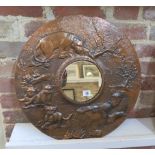 A copper relief decorated lion pride circular mirror, 52cm diameter