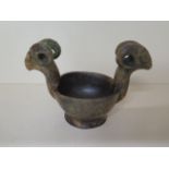 A Chinese early antique green and light brown jade mortar or bowl with ram head handles, probably