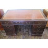 An Edwardian mahogany twin pedestal 9 drawer desk with a leather insert top, in need of some