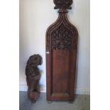 An antique part carving of a rampant lion, 71cm tall and a carved oak pew end 158cm tall x 38cm wide