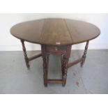 An antique oak gateleg drop leaf table with a long drawer, 69cm tall x 85cm x 106cm extended