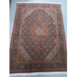 A hand knotted woollen fine Tabriz rug, 2.08cm x 1.48cm, generally good