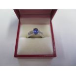 An 18ct white gold oval tanzanite and diamond ring, size K/L, tanzanite 1.07ct, AA colour,