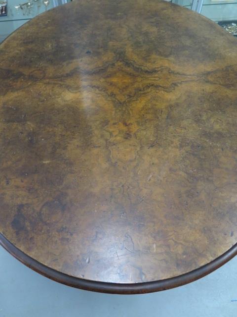 A Victorian oval tilt top walnut dining table on a quatrefoil scroll base, 76cm tall x 153cm x 121cm - Image 2 of 3