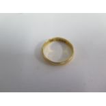 A hallmarked 22ct gold band ring, size N/O, approx 2.8 grams, some usage marks but generally good