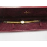 A hallmarked 9ct yellow gold manual ladies Omega bracelet wristwatch, approx 18 grams, running, with