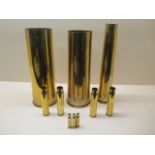 10 brass shell cases, tallest 31cm