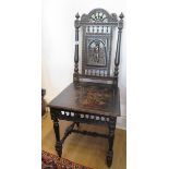 A Victorian ebonised carved hall chair