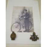 A Army Cyclist Corps cap badge, a County of London 25 cyclists cap badge and an image of a Hunts