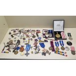 A collection of assorted medals, ribbons, badges