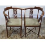 A pair of Edwardian mahogany corner chairs