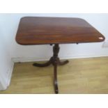 A 19th century mahogany tilt top table on a turned column and splayed tripod base, 70cm tall x