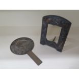 An Oriental bronze hand mirror 24.5cm long and a dragon decorated picture frame, 20cm tall
