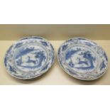 A pair of Delft bowl chargers with leading deer design, 34cm diameter x 5cm tall, both with chips to