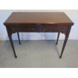 An Edwardian side / card table with 2 frieze drawers faced with blind fretwork brass knob handles,