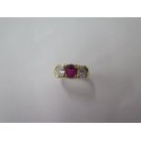 A yellow gold three stone ruby and diamond ring, each stone approx 0.25ct, diamonds bright and