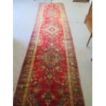 A hand knotted woollen antique Azarbaijan rug, 3.95m x 1.00m, some small wear