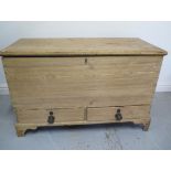 A Georgian stripped pine two drawer mule chest with an interesting papered interior and secret drawe