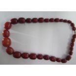 An amber type necklace 67cm long, largest bead approx 3 cm x 2.5 cm, total weight approx 156 grams