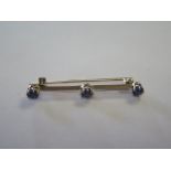 A yellow gold 3 stone sapphire bar brooch, 4.5 cm long, tests to approx 18ct, approx 3.2 grams, good