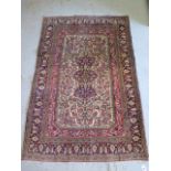 A hand knotted woollen fine Qom rug, 1.70m x 1.10m, in good condition