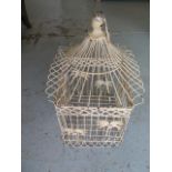 A wirework birdcage with palm tree decoration, 48cm tall x 28cm wide