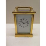 A brass French 8 day carriage clock, 13cm tall, glass good, running with key
