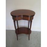 A French mahogany and oak inlaid kidney shaped 2 tier lamp table with frieze drawer with brass and