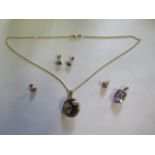 A 9ct yellow gold pendant on a 14ct 44cm chain, 2 pairs of 9ct earrings and a gilt metal pendant,