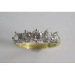 An 18ct yellow gold hallmarked 5 stone diamond ring, centre stone approx 0.30ct, size Q/R,