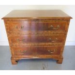 A reveneered 3 drawer chest with star inlay, standing on shaped bracket feet, 90cm tall x 95cm x