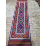 A hand knotted woollen Suzni Kilim runner, 313cm x 78cm