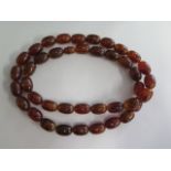 An amber style beaded necklace, 80cm long, largest bead 2cm x 1cm, approx 96 grams