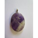 A blue John pendant in a silver mount, 5cm x 3cm, with natural flaws but good condition
