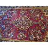 A hand knotted woollen Kashan rug, 2.15m x 1.35m, in good condition