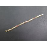 An 18ct 750 yellow gold bracelet set with three rubies / spinnels, 18cm long, approx 7.2 grams