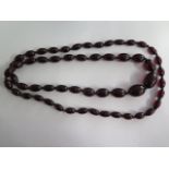 A cherry amber similar type bead necklace, 104cm long, largest bead approx 2.5 cm x 1.5 cm, approx