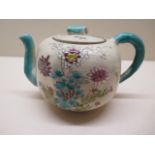 A floral decorated Oriental teapot, 15cm x 10cm tall with interesting cutting about teapots, overall