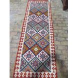 A hand knotted woollen Chobi Kilim runner, 253cm x 81cm