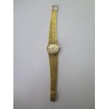 A lady's hallmarked 18ct yellow gold Omega Deville wristwatch having mechanical movement and