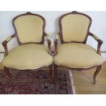 A pair of carved beechwood upholstered elbow chairs, 85cm tall x 57cm wide