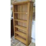 A modern oak bookcase with four fixed shelves, 180cm tall x 90cm x 30cm