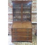 A good quality Georgian mahogany bureau bookcase with an astragal glazed top having adjustable