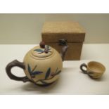 Two Chinese Yixing tea pots and covers together with a tea cup, largest 12.5cm x 18cm, two small