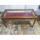 A mahogany bijouterie display table on square tapering legs with bevel edge glass to the hinged top,