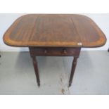 A 19th century mahogany dropleaf Pembrooke table with active and opposing dummy drawer on turned