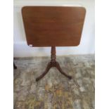 A 19th century tilt top wine table on turned column and tripod legs, 70cm tall x 61cm x 43cm, in
