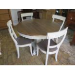 A shabby chic circular dining table on a square tapering column and quatrefoil platform base and 4